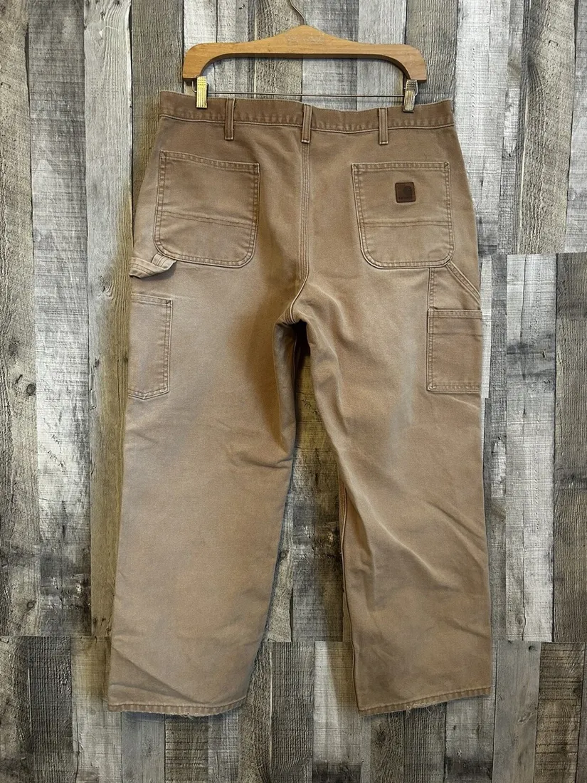 Carhartt label on dark khaki canvas carpenter pants