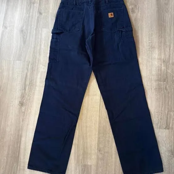 Carhartt label on dark navy cargo work pants